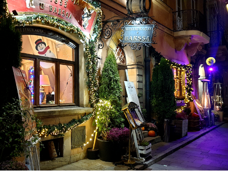 Entrance to Restaurant U Barssa adorned with festive Christmas ornaments. The inviting doorway welcomes guests with seasonal charm, setting a merry ambiance for dining and celebration during the holiday season.